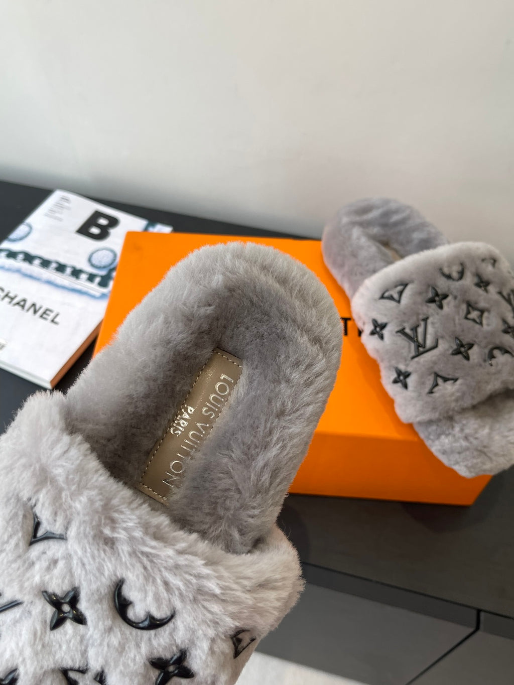 Louis Vuitton plush slide slippers, gray fur with tan branded insole and black logo