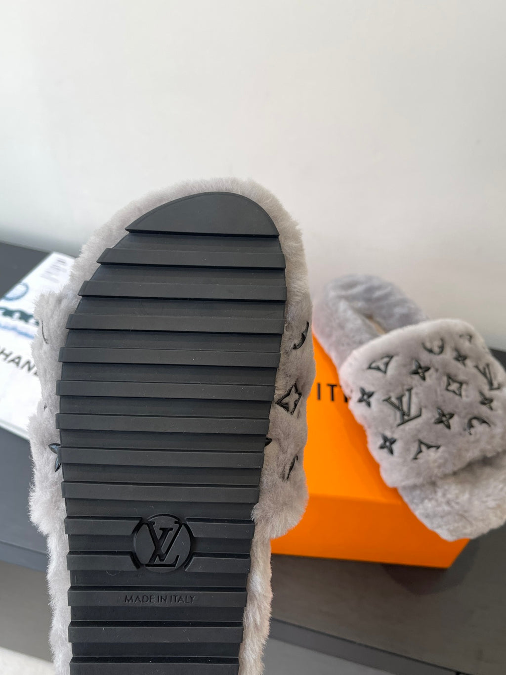 Louis Vuitton plush slippers outsole view, gray fur with ribbed black rubber sole