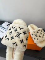 Louis Vuitton plush fur slide sandals with black monogram icons on cream