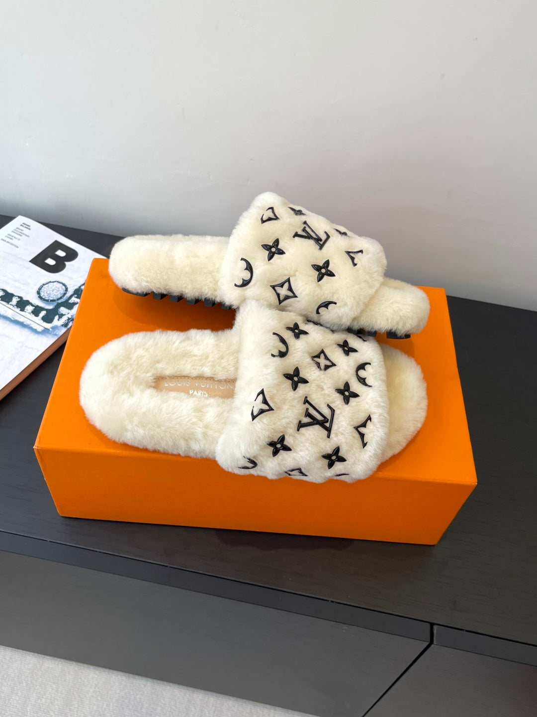 Louis Vuitton plush fur slide sandals with black monogram print on cream footbed