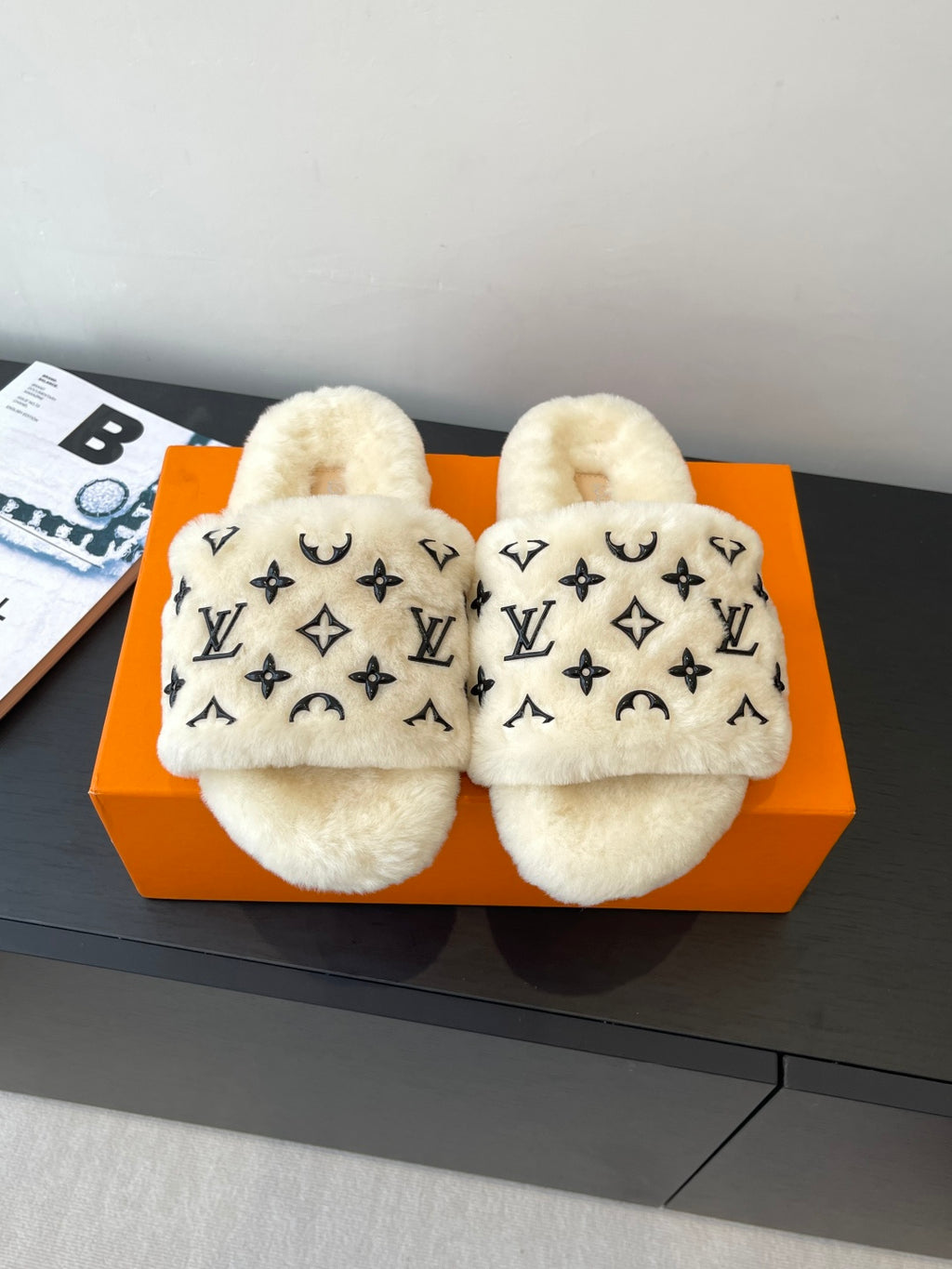 Louis Vuitton plush fur slides with black monogram pattern on cream upper