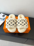 Louis Vuitton plush fur slides with black monogram pattern on cream upper