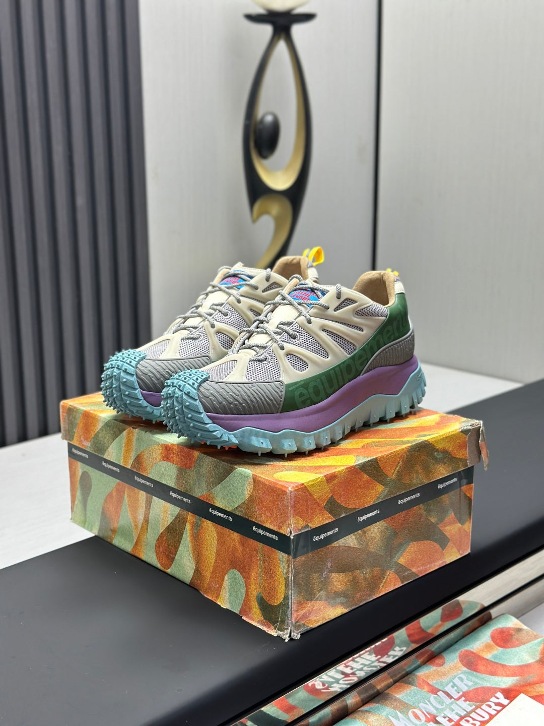 Moncler lace-up trail sneakers with beige mesh, green and purple panels, blue lug sole