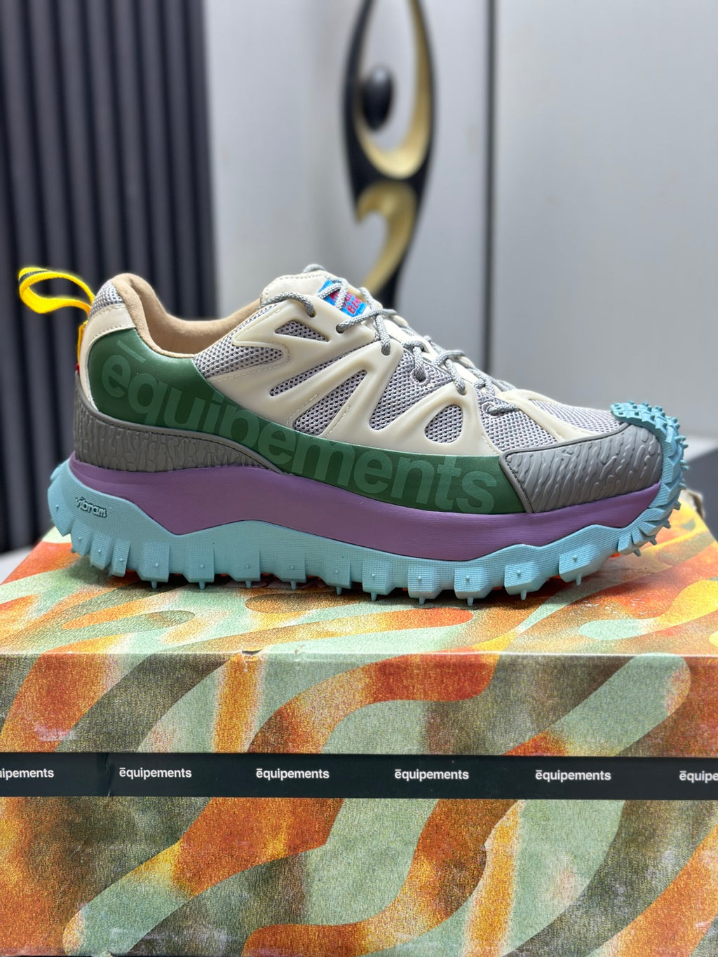 Moncler lace-up trail sneakers, beige upper with green paneling, purple midsole, blue tread