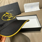Black Prada cap close-up of brim and yellow-edged stitching detail
