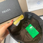 Black Prada cap underside and inside with green hang tag shown