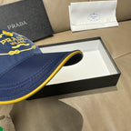 Prada cap brim detail in dark blue with yellow piping along the edge.