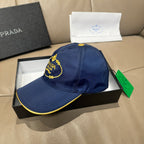 Prada cap, dark blue with embroidered PRADA MILANO badge and yellow-trim brim.