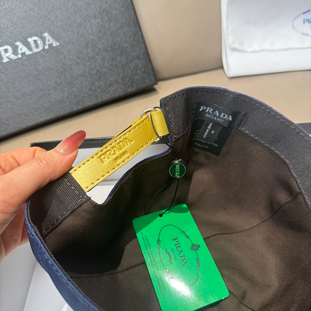 Prada cap interior view with yellow strap detail and green authenticity tag.