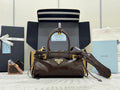 Prada brown leather satchel with top handles, front logo plaque, and gold hardware