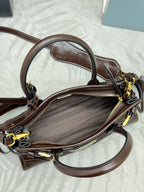 Prada brown leather crossbody bag with fabric-lined interior and gold zipper hardware