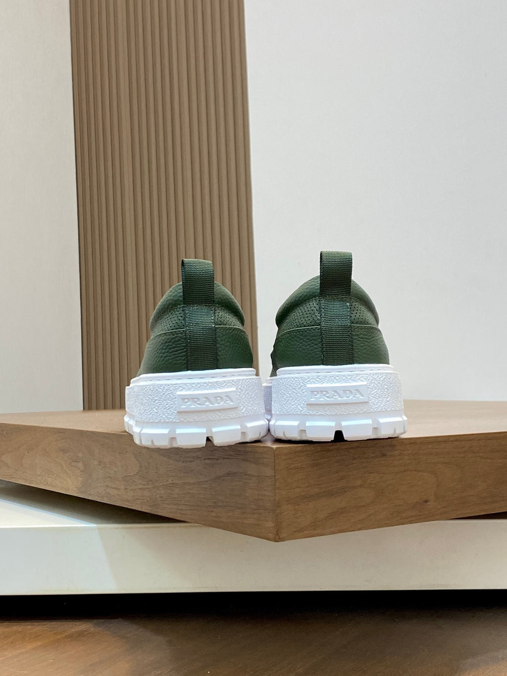 Prada unisex slip-on shoes, back view with green heel and white outsole