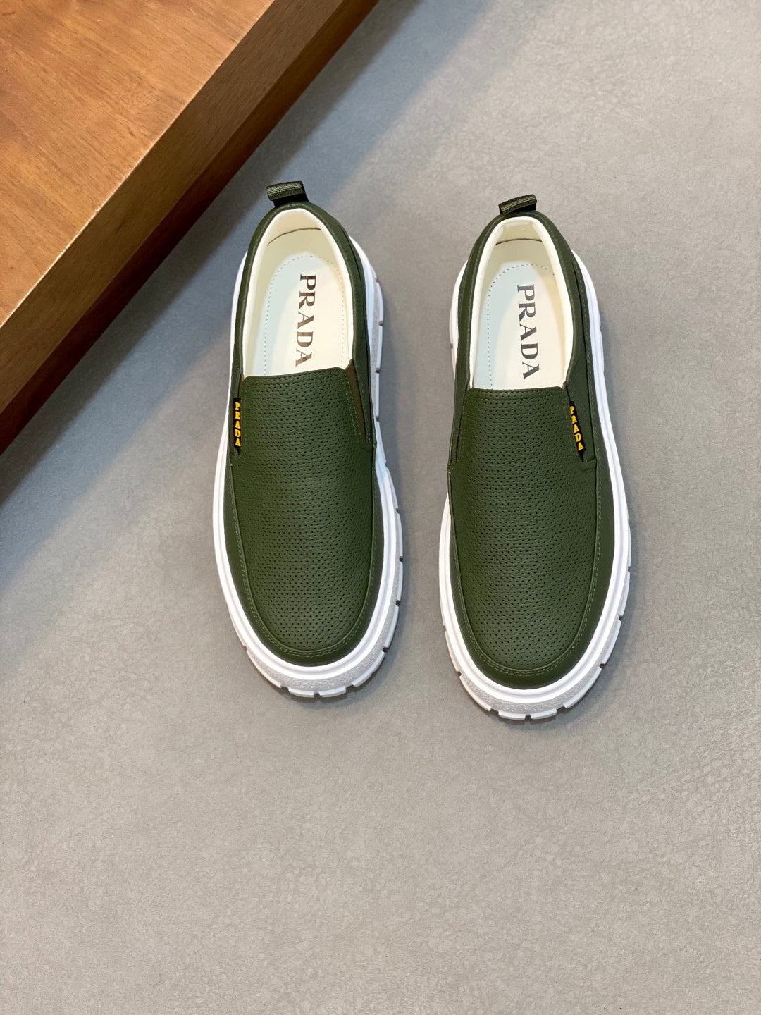 Prada unisex slip-on shoes with green textured upper and white rubber sole