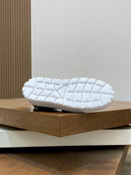 Prada unisex slip-on shoe outsole view, white tread sole on display