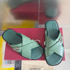 Gucci green slide sandals with cross straps and silver G buckle hardware