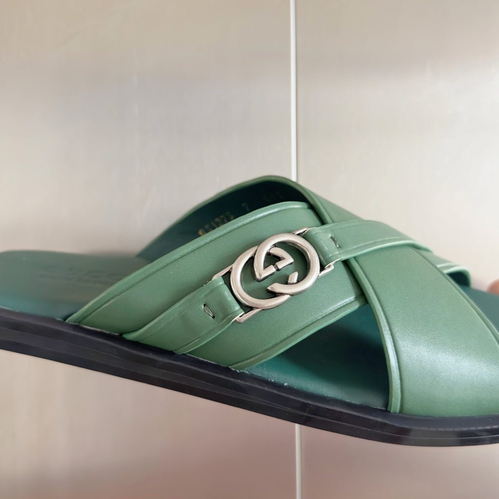 Gucci green leather slide sandal with silver interlocking G buckle close-up