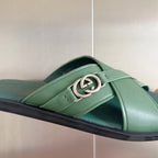 Gucci green leather slide sandal with silver interlocking G buckle close-up