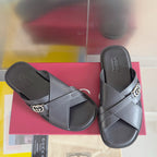 Gucci black leather slide sandals with crossed straps and silver G buckle