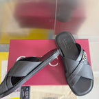 Gucci black slide sandals with crossover strap and silver G buckle, side view