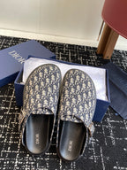 Dior sandals with Oblique pattern crossover straps, black footbeds, and logos