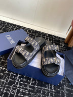 Dior slide sandals with blue patterned two-strap design and black adjustable buckles