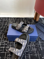 Dior slide sandals on box, black footbeds with blue patterned strap and buckle
