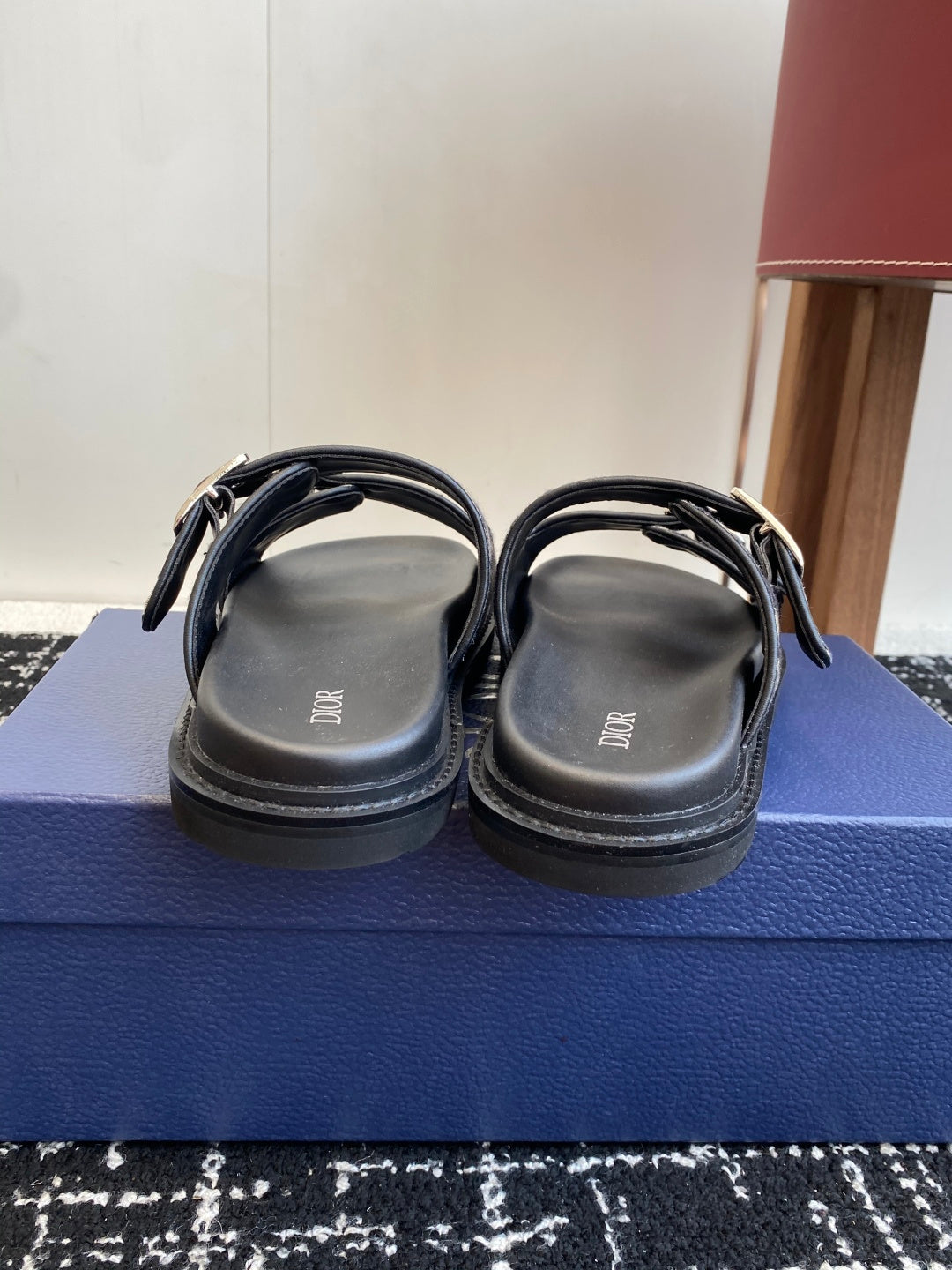 Dior slide sandals back view with black straps and blue patterned strap details