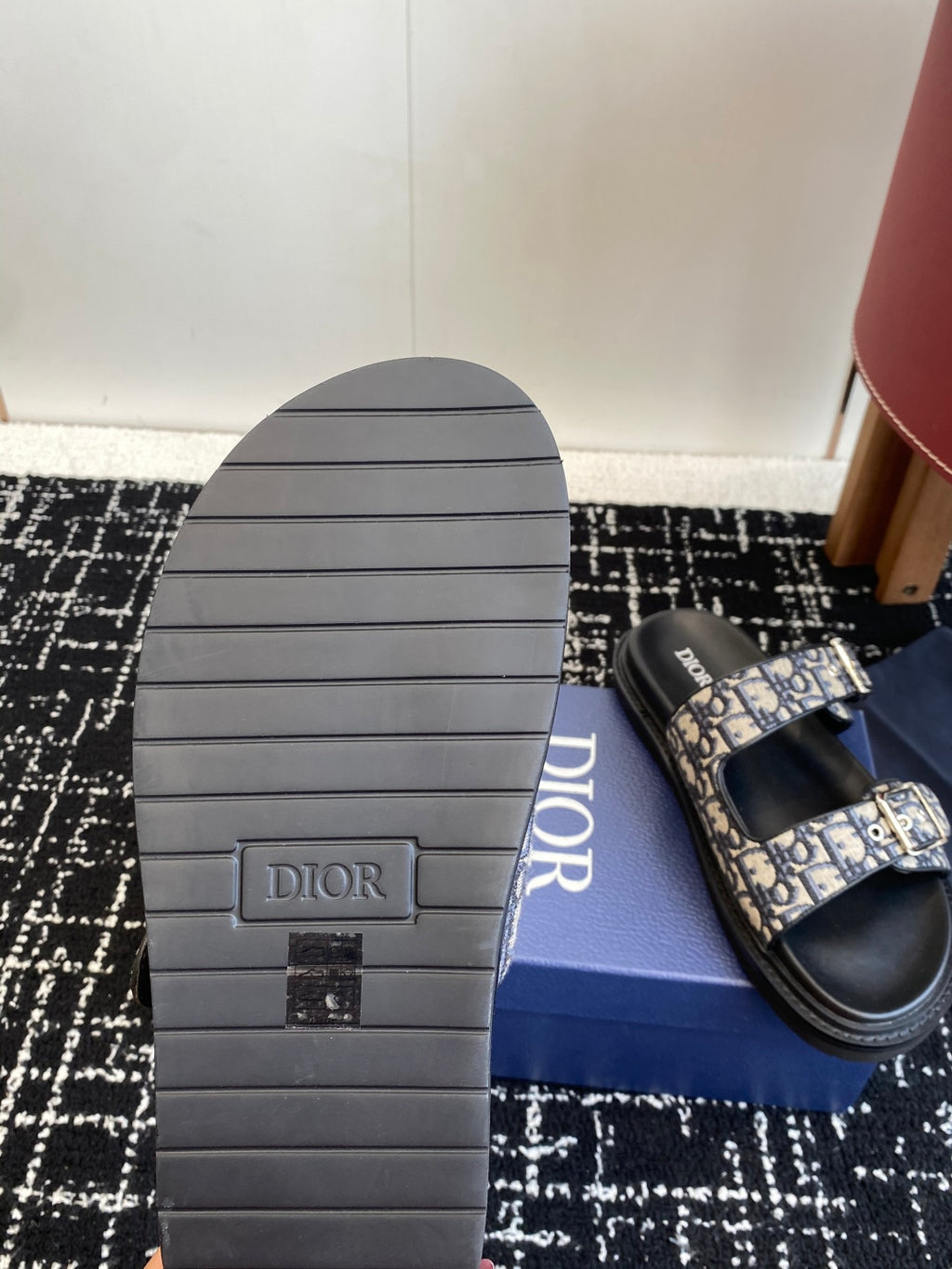 Dior sandal sole with grooved rubber tread and blue patterned strap