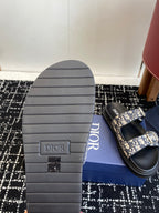 Dior sandal sole with grooved rubber tread and blue patterned strap
