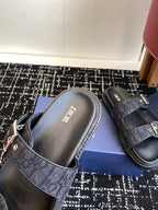 Dior slide sandal with dark blue patterned strap and silver buckle, molded footbed