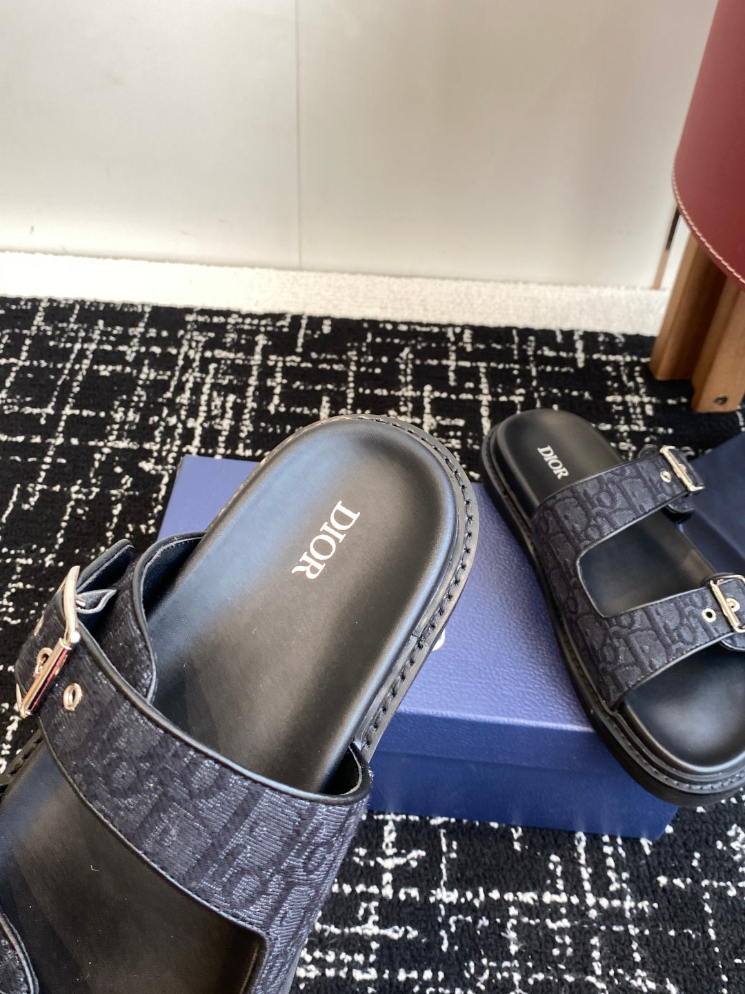 Dior slide sandal with dark blue patterned strap and silver buckle, molded footbed