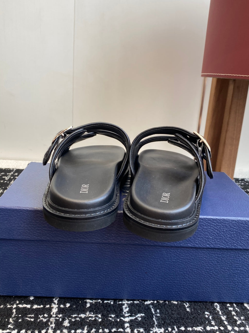 Dior slide sandals with dark blue patterned straps and silver buckles, rear view