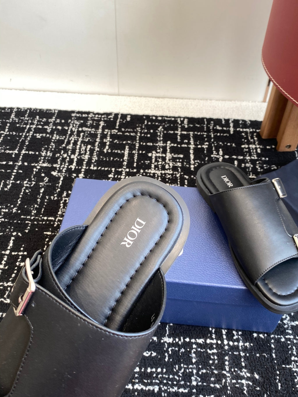 Dark gray leather Dior slide sandals, close-up of cushioned footbed and strap