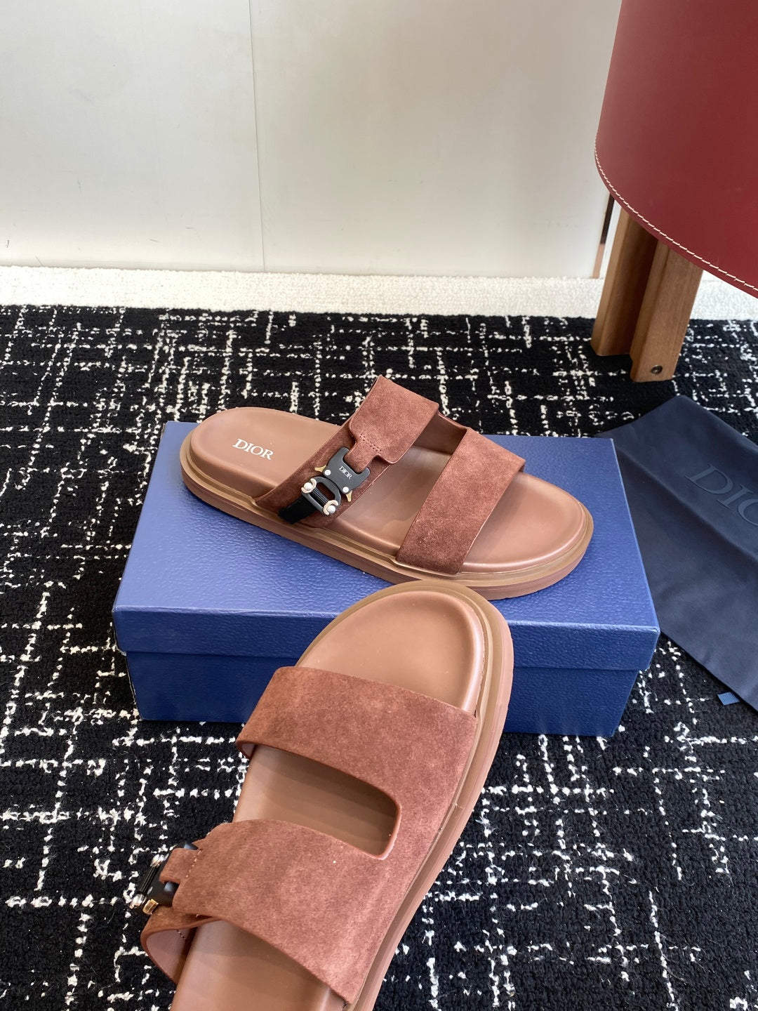 Dior slide sandals in brown suede with metal buckle and open-toe footbed, side view