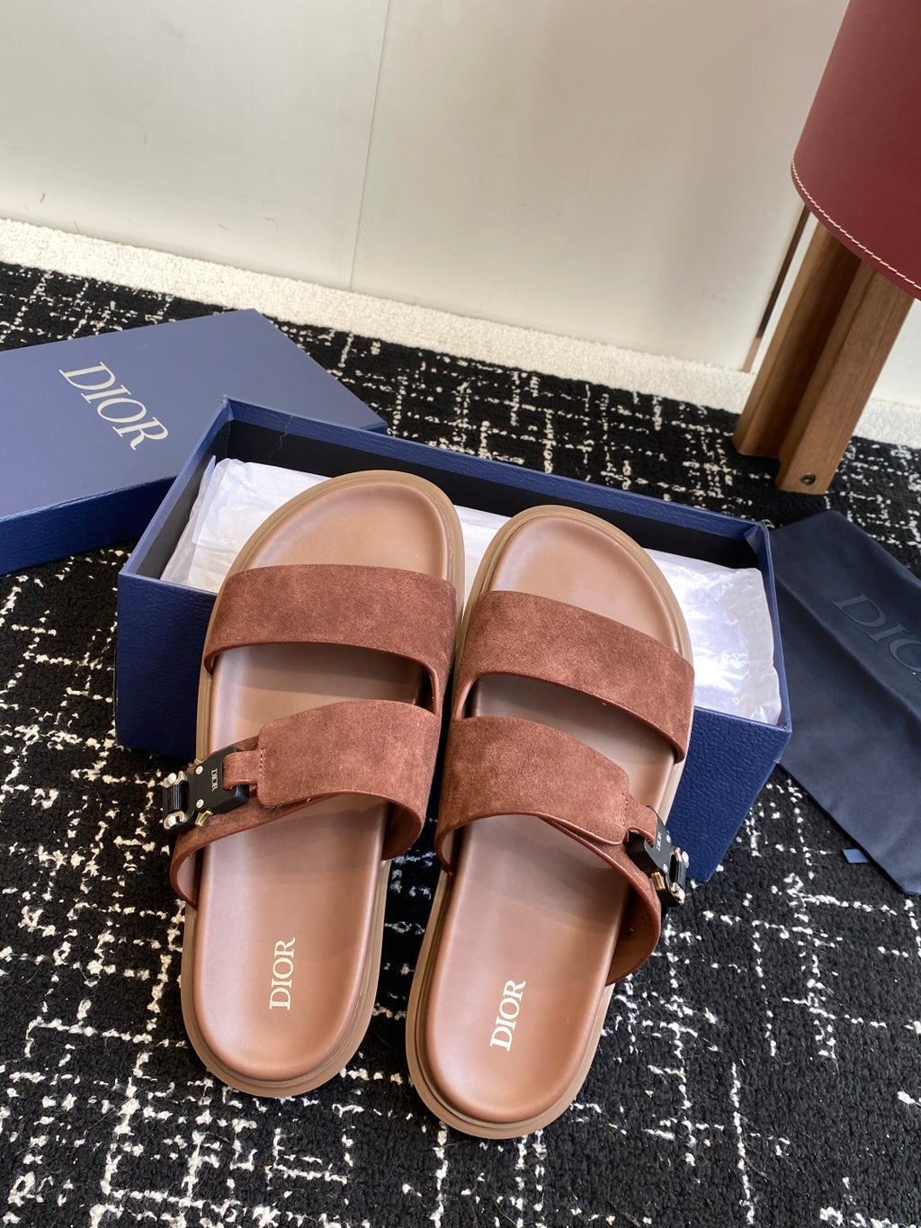 Dior slide sandals in brown suede with two straps and metal buckles, front view