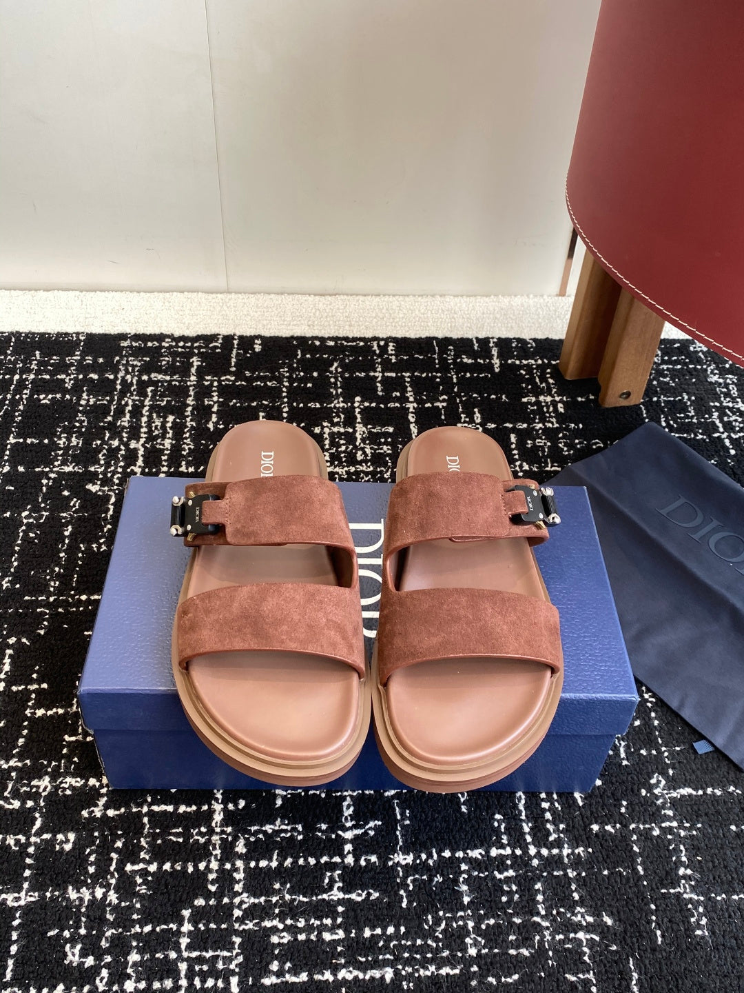 Dior slide sandals in brown suede with two straps and metal buckles, on box