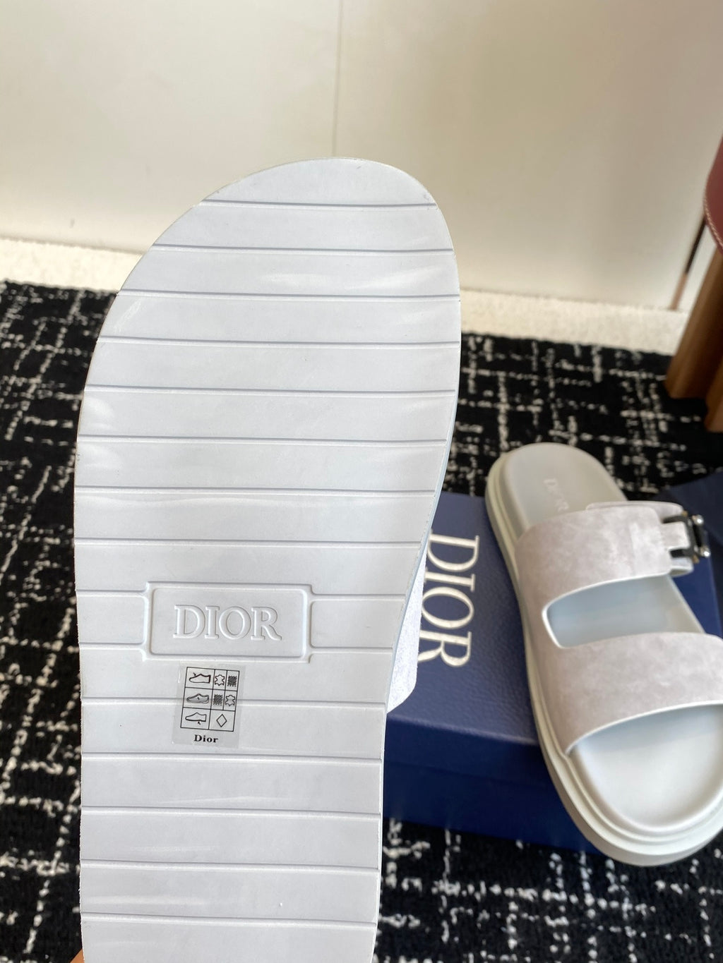 Dior sandal outsole with tread, paired with light gray suede slide upper and silver buckle