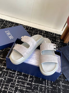 Dior slide sandals with light gray suede upper, silver buckle detail and white sole