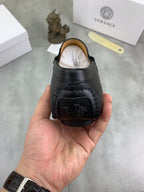 Black leather loafer with open heel lining, back view