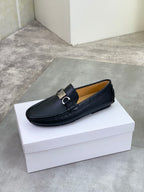 Black leather loafer with silver buckle, slip-on design