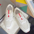 Prada unisex sneakers, white mesh upper with red logo stripe and lace-up front