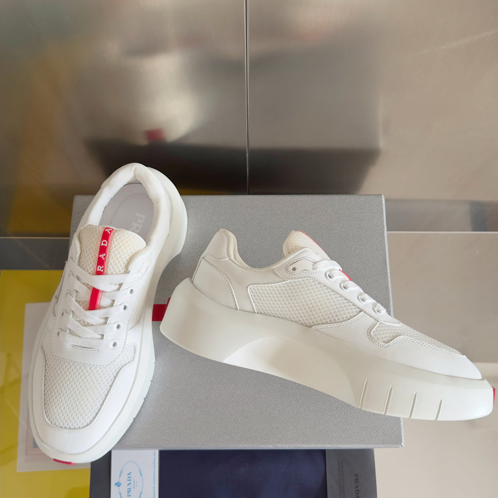 Prada unisex sneakers, side view with white mesh and smooth leather overlays