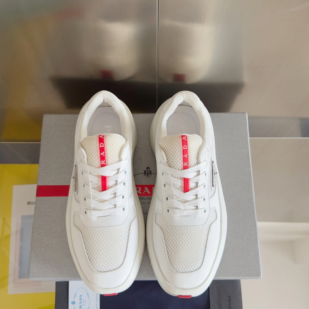 Prada unisex sneakers, pair view with white mesh uppers and red-and-white logo details