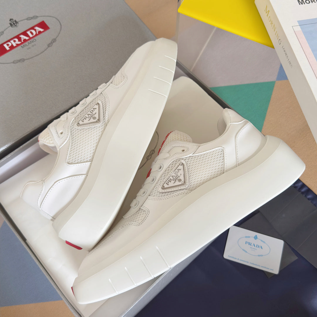 Prada unisex sneakers, angled view showing white platform sole and triangular logo
