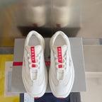 Prada white sneakers with red-logo tongue tabs and rubber outsole