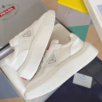 Prada white sneakers with mesh-textured uppers, side badge, and thick sole