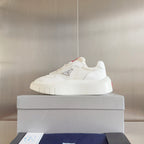 Prada white low-top sneakers with cushioned sole and logo badge on side