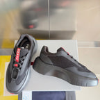 Prada unisex sneakers, dark gray knit-texture upper, chunky gray sole, red trim