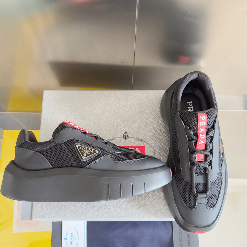 Prada unisex sneakers, dark gray mesh and matte panels, red logo tabs, chunky sole