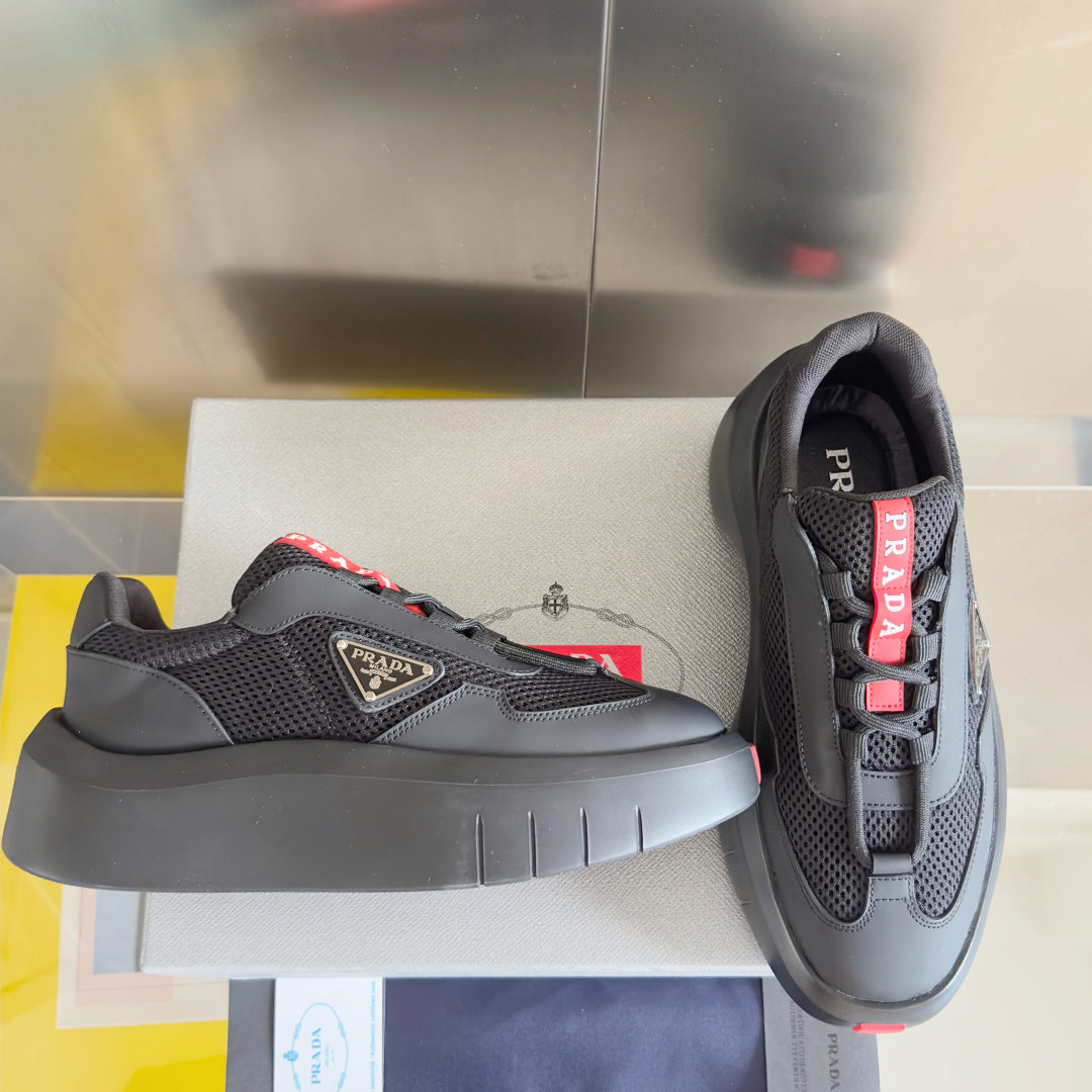 Prada unisex sneakers, dark gray mesh and matte panels, red logo tabs, chunky sole